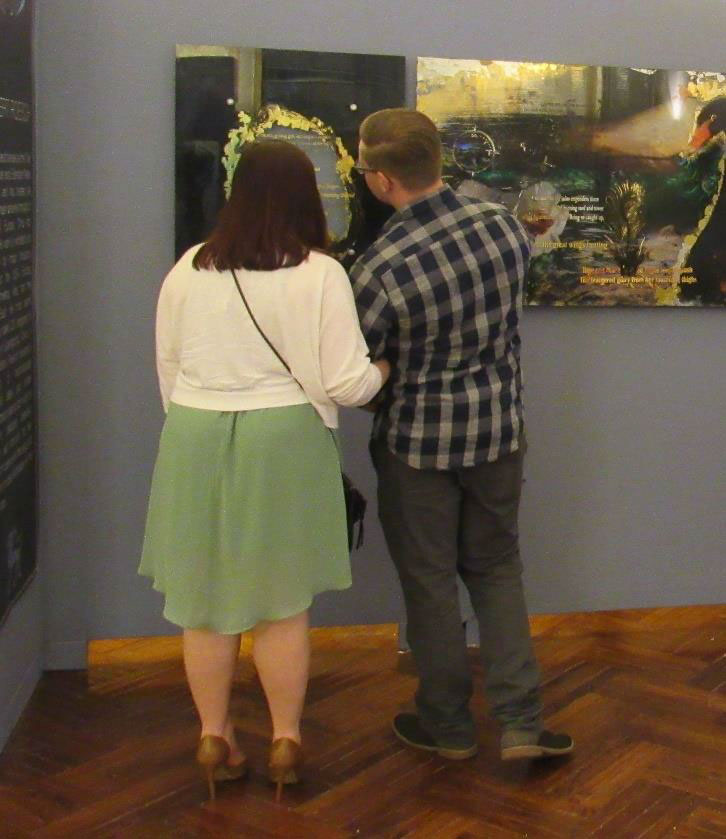 Two guests marvel over one of Suzanne's mirror paintings